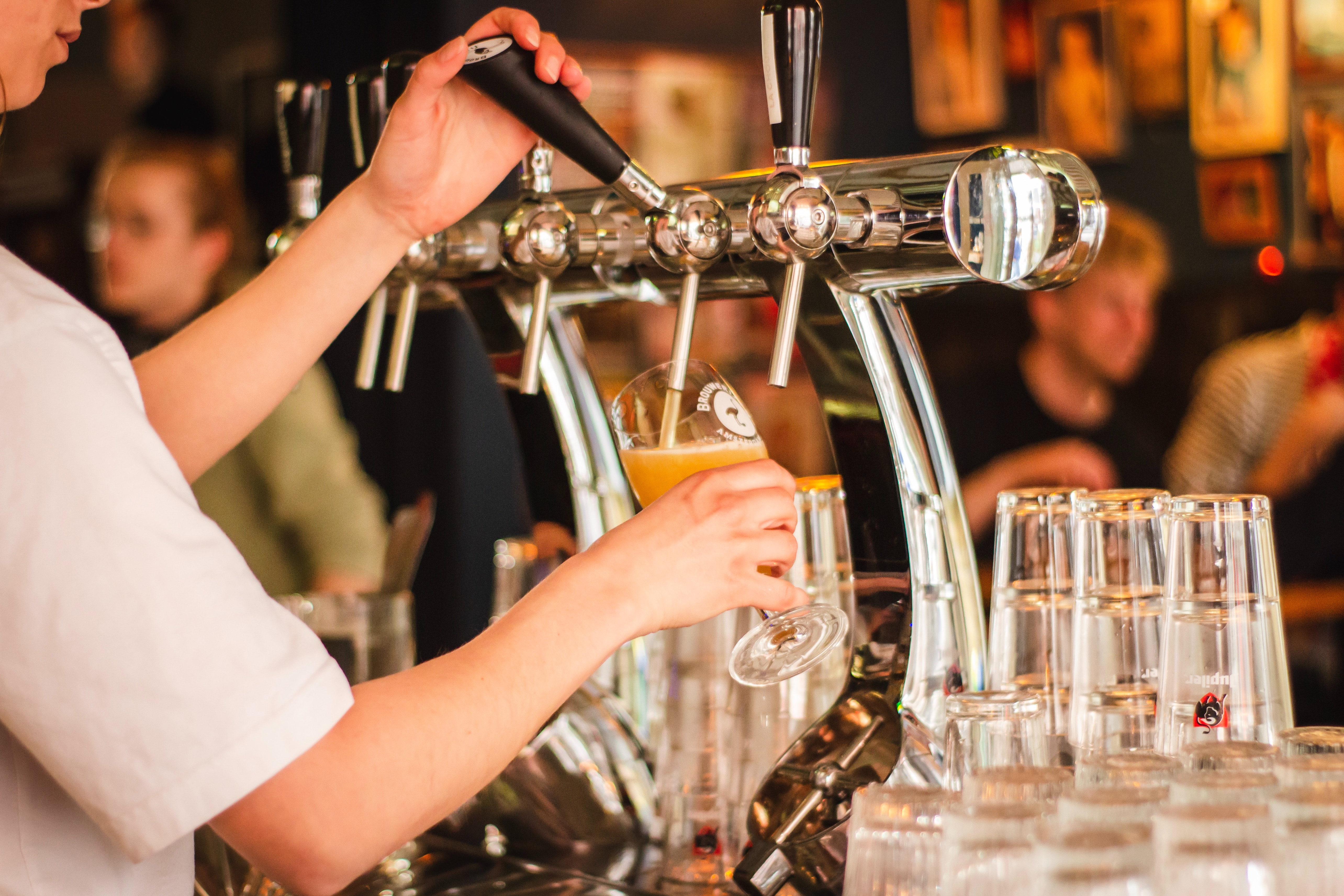 Bartender pouring a fresh pint of lager