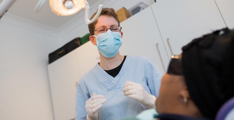 Dentist talking with their patient sitting in the chair