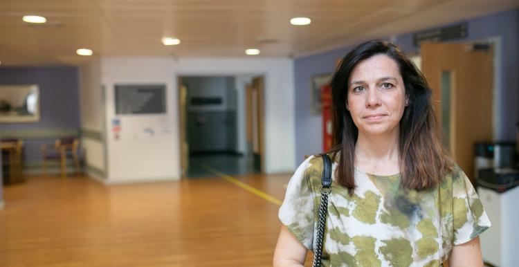 A woman standing in the main reception at hospital.