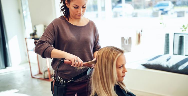 A woman sitting getting her hair done at a hairdressers