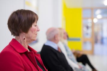 Patients sitting in a hospital waiting room.