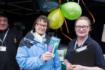 Healthwatch volunteer at an event speaking to the public