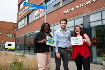 Healthwatch staff members standing outside a hospital 