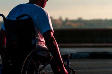 Boy pushing himself in a wheelchair 