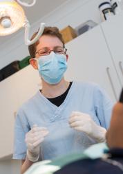 Dentist talking with their patient sitting in the chair