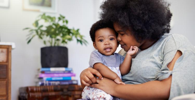 Woman holding her baby on her lap